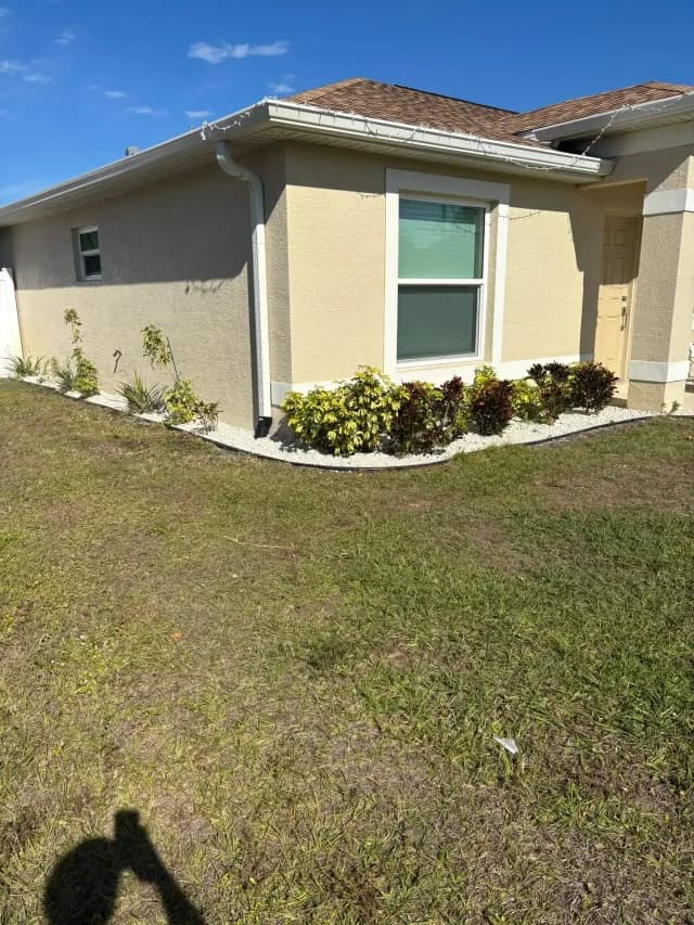Foundation shrubs mulched and shaped along a house exterior