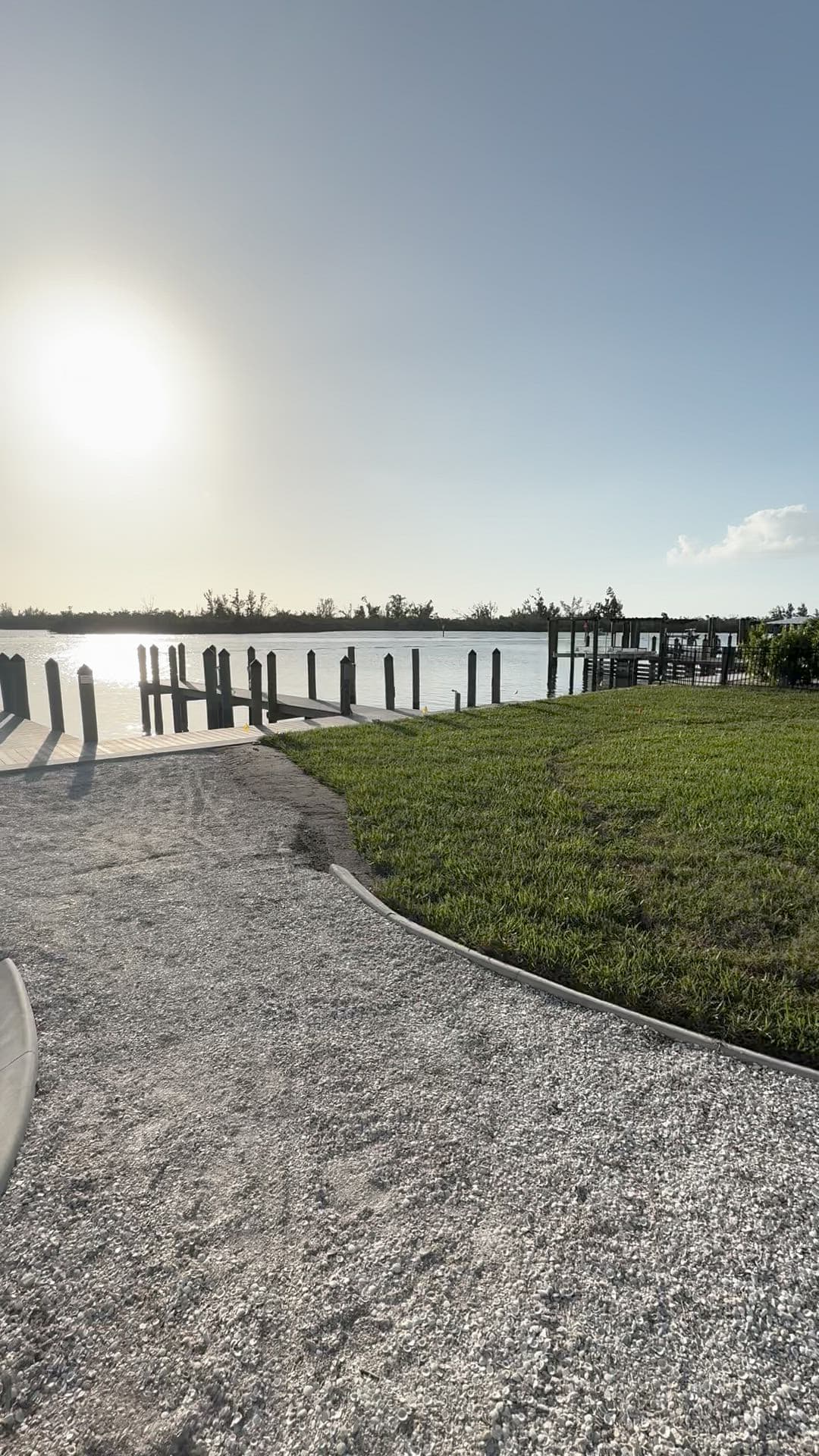 Mowed lawn edge along a canal-front dock in Southwest Florida